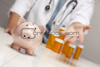 Doctor Wearing Stethoscope Reaches Palm Out Behind Medicine Bottles and Piggy Bank.