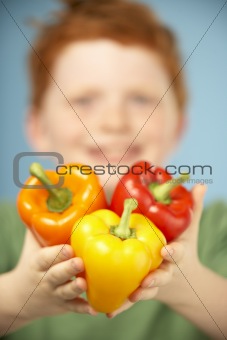 Young Boy Holding Colourful Peppers