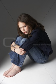 Thoughtful Girl Sitting In Studio
