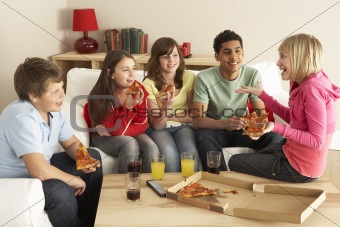 Group Of Children Eating Pizza At Home
