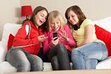 Group Of Three Girls Reading Text Message