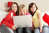 Group Of Three Girls Using Laptop At Home