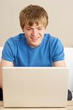 Young Boy Using Laptop At Home