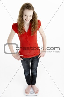 Happy Young Girl Standing On Scales