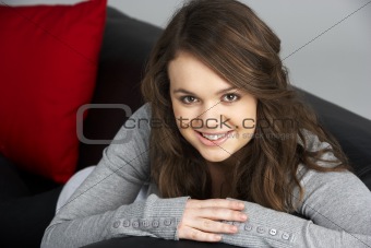 Teenage Girl Sitting On Sofa