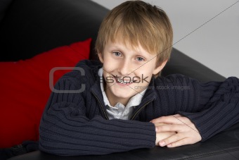 Teenage Boy Sitting On Sofa