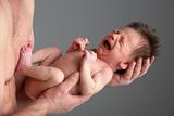 Crying Newborn Baby Held By Father