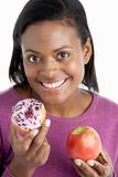 Woman Choosing Between Apple And Doughnut