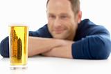 Man Looking At Glass Of Beer