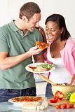 Young Couple Eating Meal In Kitchen