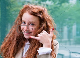 Outdoor portrait young woman talk on a cellular telephone 