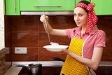Beautiful happy woman in kitchen interior cooking