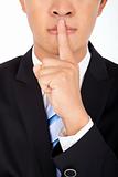 businessman showing quiet gesture with his finger