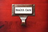 Lustrous Wooden Cabinet with Health Care File Label in Dramatic LIght.