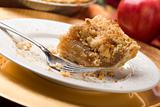 Half Eaten Apple Pie Slice with Crumb Topping and Fork.