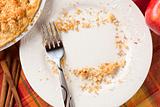 Overhead Abstract of Apples, Cinnamon Sticks, Pie and Empty Plate with Remaining Crumbs Cleared Into Rectangular Copy Room Space and Fork - Ready for Your Own Message.