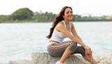 Attractive woman sitting on the rocks