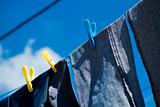 Washed blue jeans drying outside