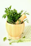 herbs in wooden mortar with pestle