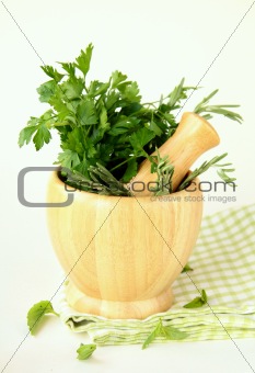 herbs in wooden mortar with pestle
