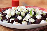 appetizer salad of beets and goat cheese with basil and olive oil