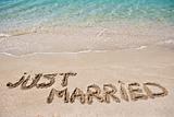 Just married written on the sand
