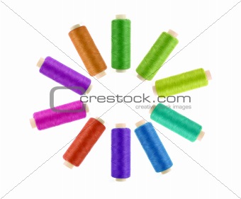 Multicolor sewing threads on white background