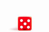 Detail of one red dice on white background