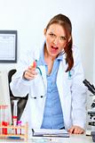 Angry doctor woman shouting and pointing on you

