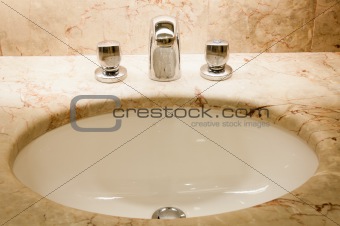 Faucet with handles and white sink