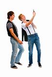 Two teenage boys making photos on cell phone. Isolated on white
