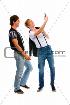 Two teenage boys making photos on cell phone. Isolated on white
