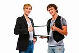 Two happy young men showing laptops blank screen. Isolated on white
