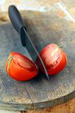 ceramic knife and tomato  on wooden table