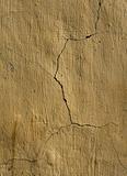 Cracked yellow plaster wall