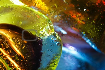 Bright colorful abstract background. Glass and drops of water.