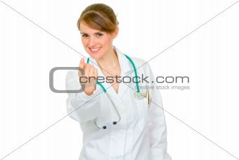 Medical doctor woman making beckoning gesture
