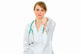 Serious medical doctor woman showing thumbs down
