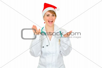 Happy medical female doctor in Santa hat clapping hands
