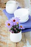 Spring table setting with lilac napkin and flowers