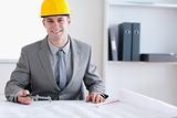 Smiling architect working on a plan