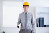 Architect wearing helm and carrying plans
