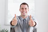 Businessman giving thumbs up