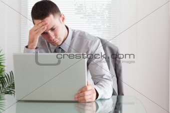 Businessman looking at his laptop