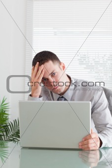Close up of businessman having a problem with his laptop