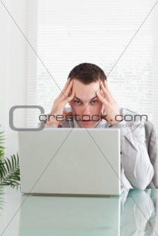 Close up of disappointed businessman getting bad news via email