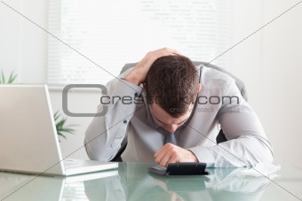 Businessman unhappy with his calculations
