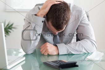 Close up of businessman unhappy about his calculations