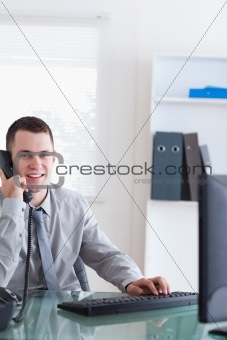 Smiling businessman listening to caller