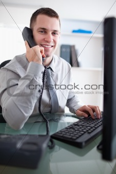 Smiling businessman having a dialogue on the phone